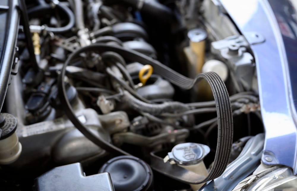 A worn serpentine belt that is on the brink of breaking.