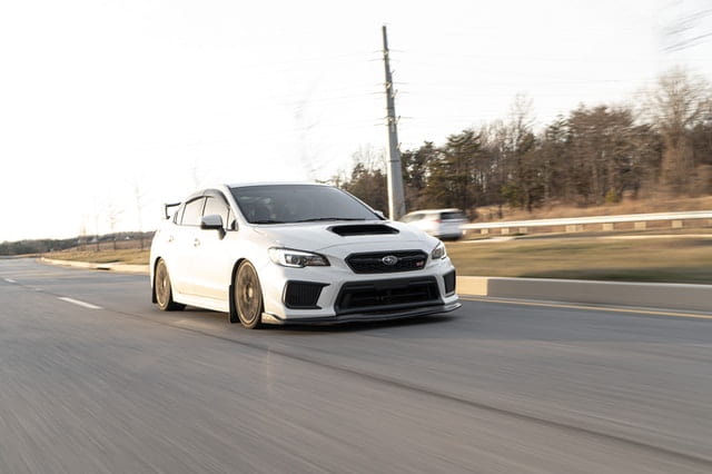 White Subaru WRX Driving Down The Highway